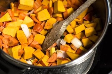 Diced vegetables for a pumpkin soup in the pot  - close-up