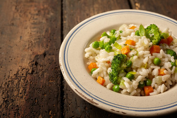 Single serving of rice and veggies on wood table