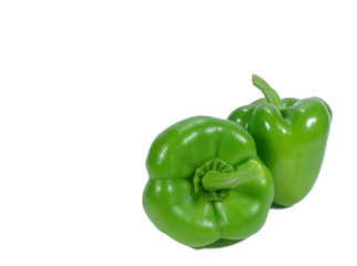Close-up of two ripe green bell peppers with stem isolated on white background