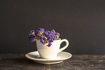 Obraz na płótnie Canvas Dried Flowers in a White Coffee Cup