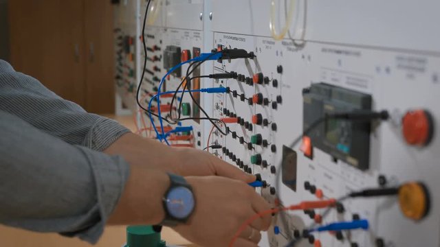 Intern in lab connect the cables to the device