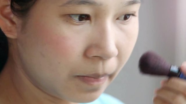 woman applying make up by rouge, brusher
