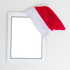 Flat lay, top view office table desk. Christmas workspace with tablet on white background, copy space on blank screen