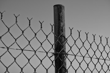 Chain link fence against blue sky