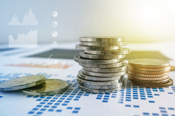 Coin stacks on paper of financial graph. Graphics icons, worldwi