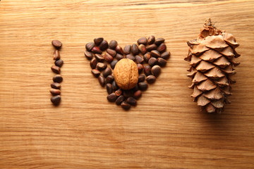 Walnut and pine nuts on a cutting board made of oak/ Walnut and pine nuts on a cutting board made of oak. Pine cones