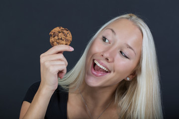 Happy girl showing a cookie