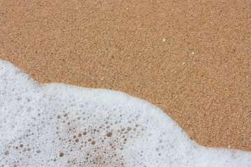 Sea foam and sand