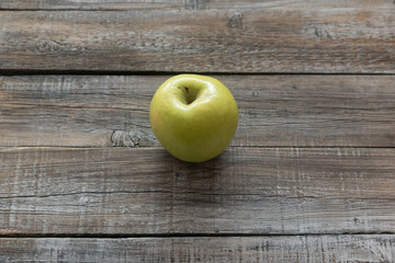 Orcanic yellow apple on wooden boards background. Autumn concept
