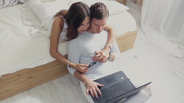 young couple with laptop and card. Online shopping