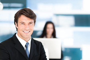 Businessman and Businesswoman in Office