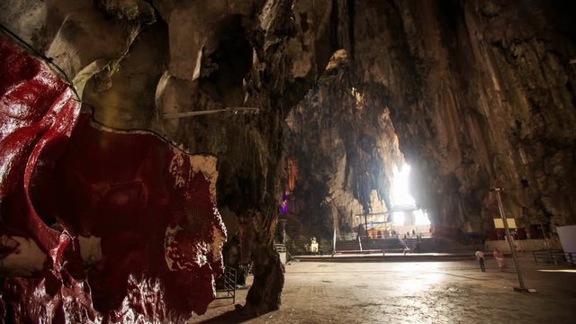 Interior View of Dark Rocks with Sun Rays inside Batu Caves