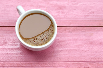 hot coffee in a white Coffee cup on Pink wooden table.