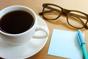 Paper note on the wooden work table.
