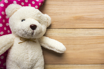teddy bear and hankie on wood backgrounds