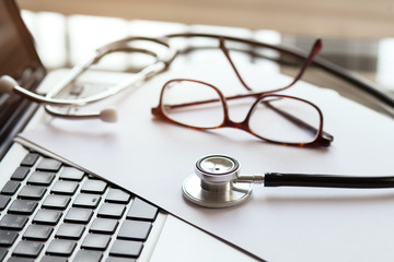 doctor online, medical concept, stethoscope and glasses on laptop, diagnosis