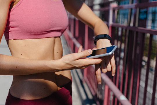 Beautiful Fit Female Runner Using A Sportwatch . Williamsburg Bridge Brooklyn NYC 