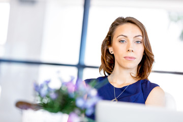 Young businesswoman sitting at desk and working