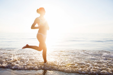 Fototapeta na wymiar Caucasian woman jogging at seashore