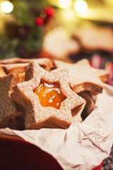 Homemade christmas cookies with jam in a bowl, christmas background and decoration, closeup, selective focus