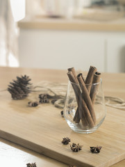 Cinnamon sticks in glass on wooden board ( Vintage tone color )