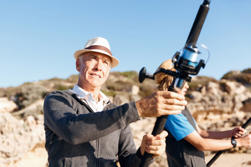 Fototapeta premium Senior man fishing with his grandson