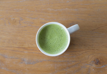 Closeup one  cup of hot Green Tea on clean wooden table background