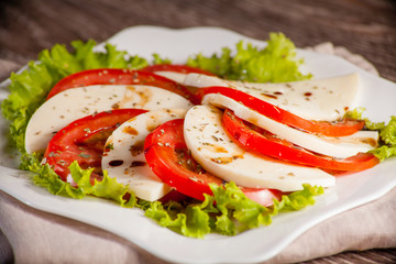 whim on a white plate, on a linen towel on wooden background sca