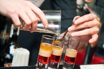 Barman or bartender preparing alcohol cocktail in restaurant