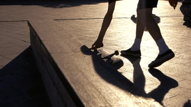 Legs walk in slow-mo. Skateboard on pavement. Make another attempt. Progress demands motivation.