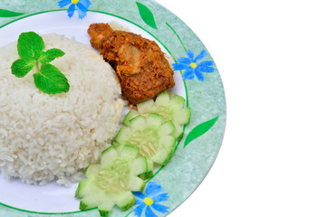 Nasi lemak traditional malaysian spicy rice dish. Served with chicken rendang. Malaysian food