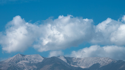 The picturesque mountain on the background of cloud stream. Wide angle