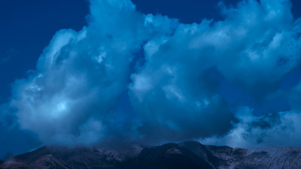 The beautiful mountain on the background of cloud stream. Wide angle