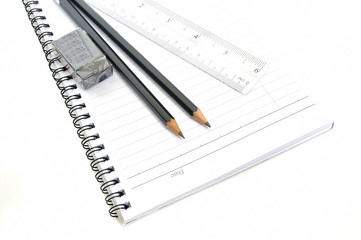 Naklejka premium Blank page with pencils, eraser and ruler isolated on white background