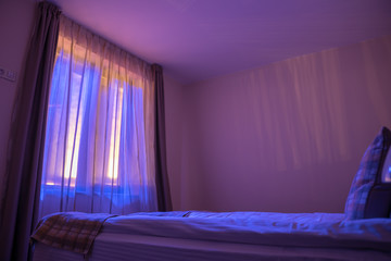 The bright light from the window in the bedroom. Evening night time