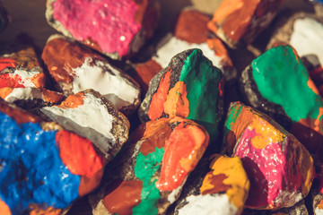 paint spreads on the surface of small stones