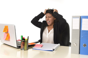  businesswoman suffering stress working at office computer desk worried desperate