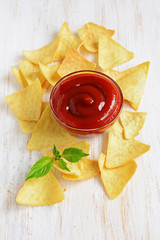 Nachos corn chips and red sauce