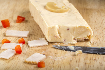 Block of melted cheese with ham, red pepper and mushrooms