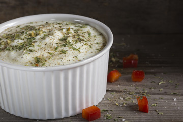 Sauce made from yogurt and herbs and black pepper in bowl