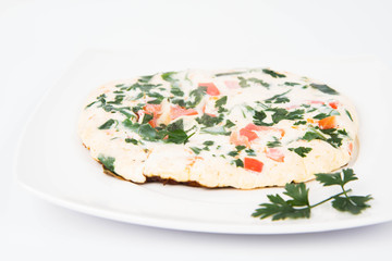 Omelette with tomatoes, fresh spinach and parsley