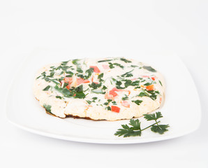 Omelette with tomatoes, fresh spinach and parsley
