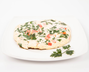 Omelette with tomatoes, fresh spinach and parsley