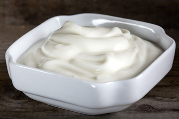 Bowl of sour cream or yogurt in white bowl