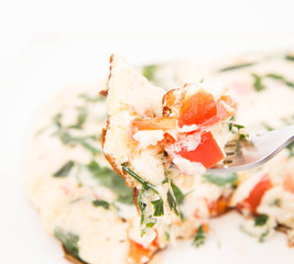 Omelette with tomatoes, fresh spinach and parsley