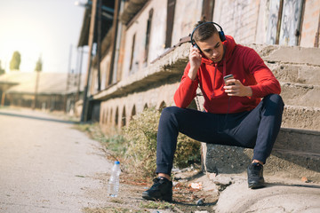 running man setting play list on his smartphone