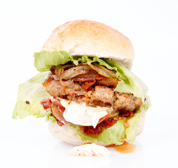 Hamburger with fried onion, tomatoes, iceberg lettuce, mayonnaise and ketchup