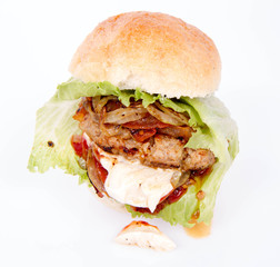 Hamburger with fried onion, tomatoes, iceberg lettuce, mayonnaise and ketchup