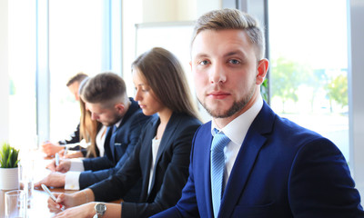 Businessman with colleagues in the background in office