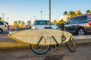 Hawaii surfing bicycle standing on the road with a surf board on